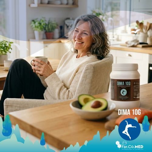 Fotografia lifestyle in stile professionale che ritrae una donna di mezza età dall'aspetto sano e radioso, seduta in una cucina moderna e luminosa. In primo piano, su un bancone di legno, sono disposti degli integratori per dieta chetogenica (barattolo Dima 10G Gusto Cacao) accanto a ingredienti naturali come avocado fresco e salmone, simboli di un'alimentazione bilanciata e salutare.